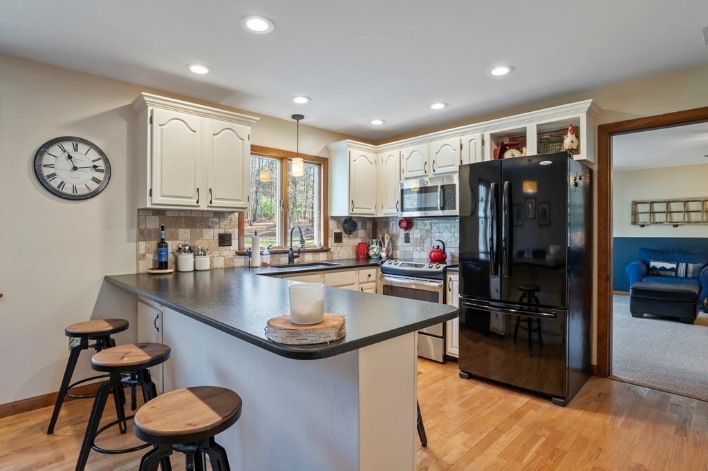 83 Thayer Road Monson, MA 01057 - Photo 15 of 42 a kitchen with a table chairs stove and refrigerator
