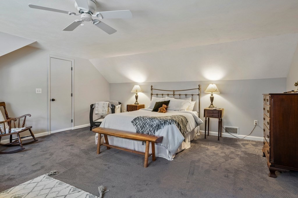 83 Thayer Road Monson, MA 01057 - Photo 30 of 42 a spacious bedroom with a bed and a chandelier