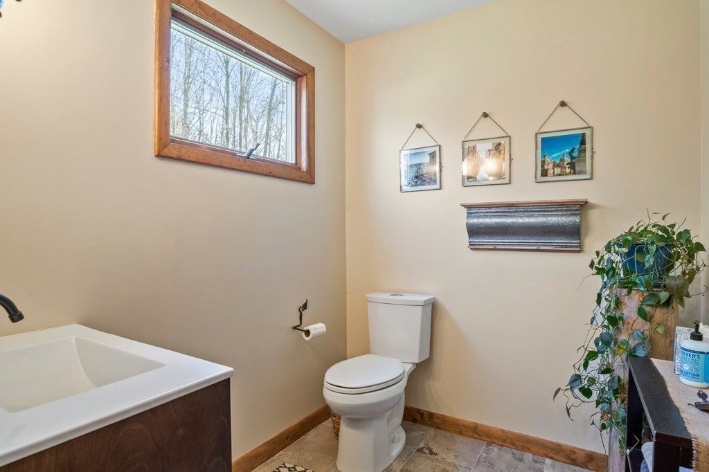 83 Thayer Road Monson, MA 01057 - Photo 10 of 42 a bathroom with a toilet a sink and a mirror