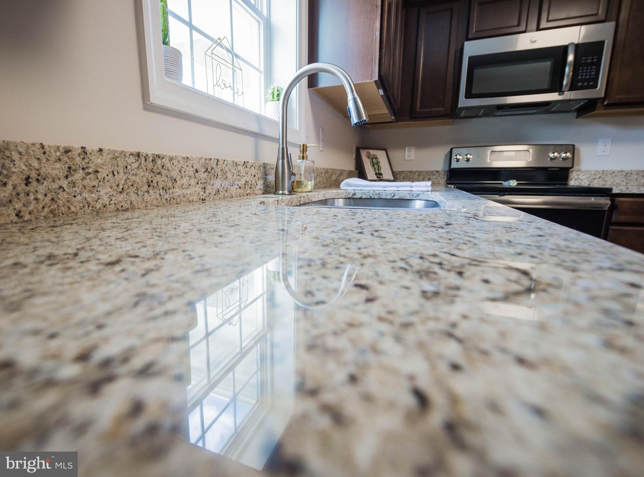113 Morgan Run Snow Hill, MD 21863 - Photo 13 of 35 a kitchen with granite countertop a sink and a microwave