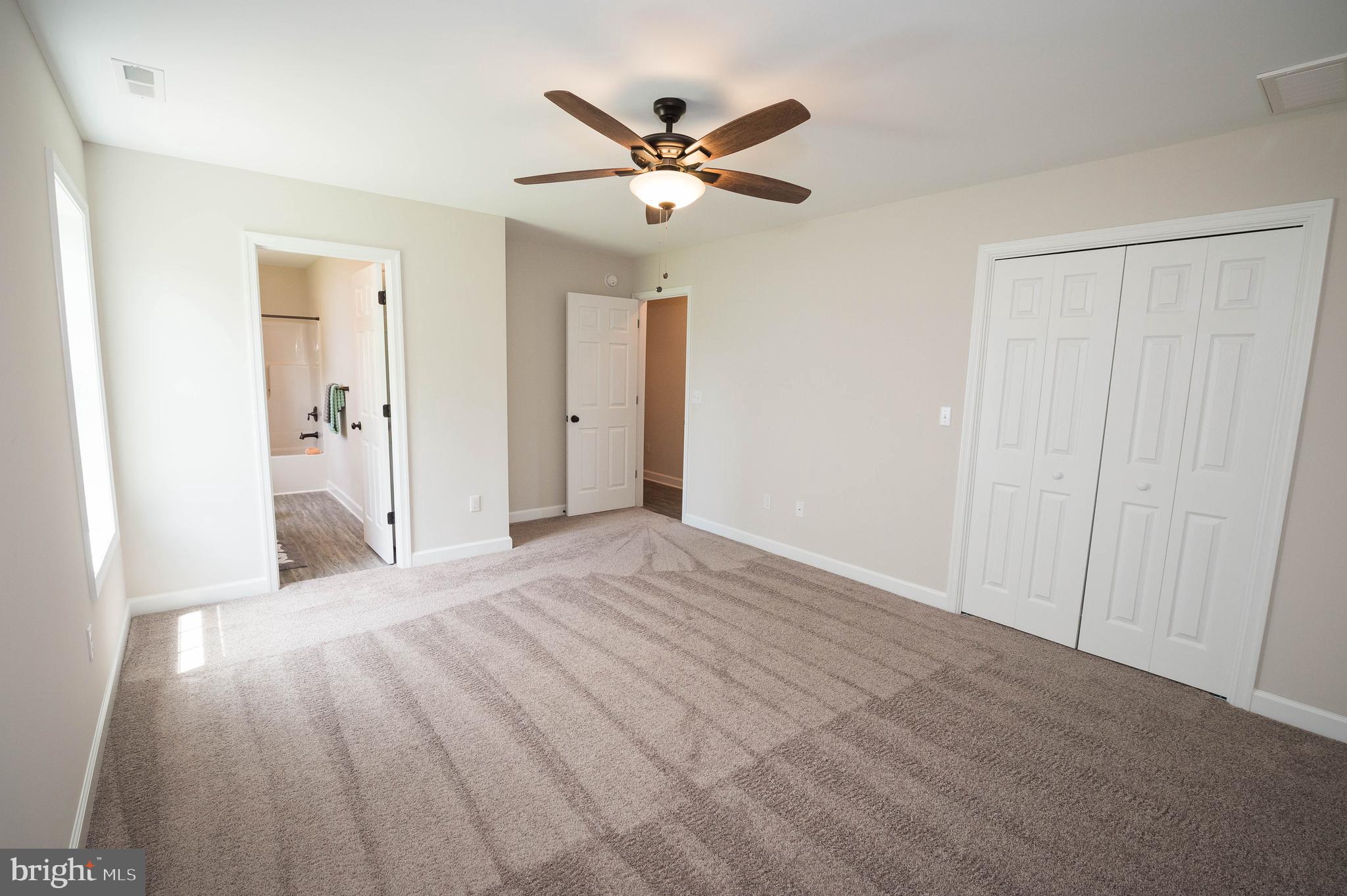 113 Morgan Run Snow Hill, MD 21863 - Photo 16 of 35 a view of a livingroom with a ceiling fan & wooden floor