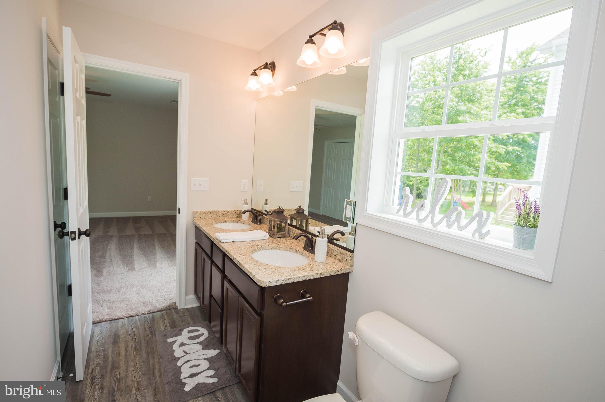 113 Morgan Run Snow Hill, MD 21863 - Photo 19 of 35 a bathroom with a sink toilet and mirror