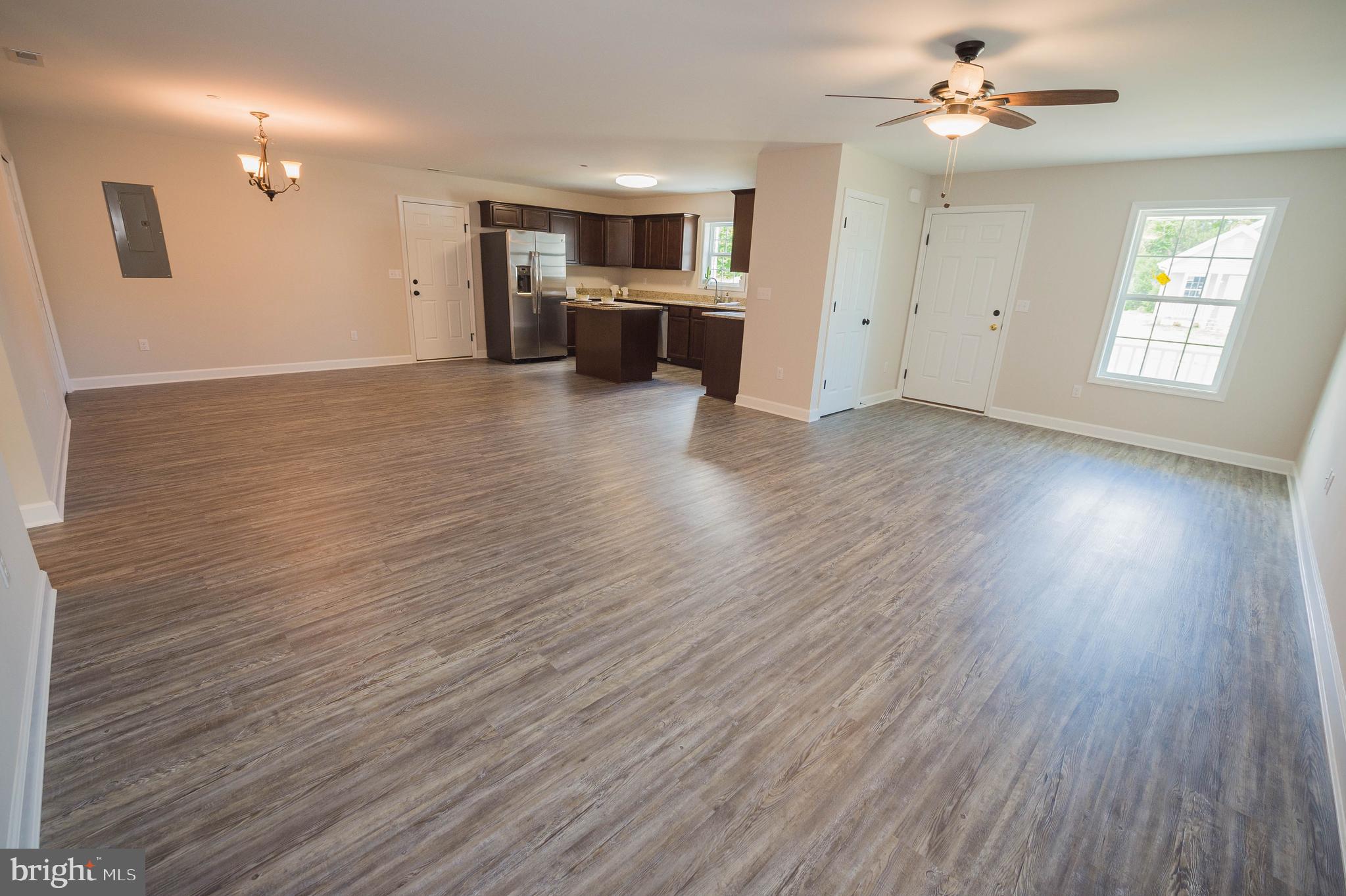 113 Morgan Run Snow Hill, MD 21863 - Photo 3 of 35 an empty room with wooden floor and ceiling fan