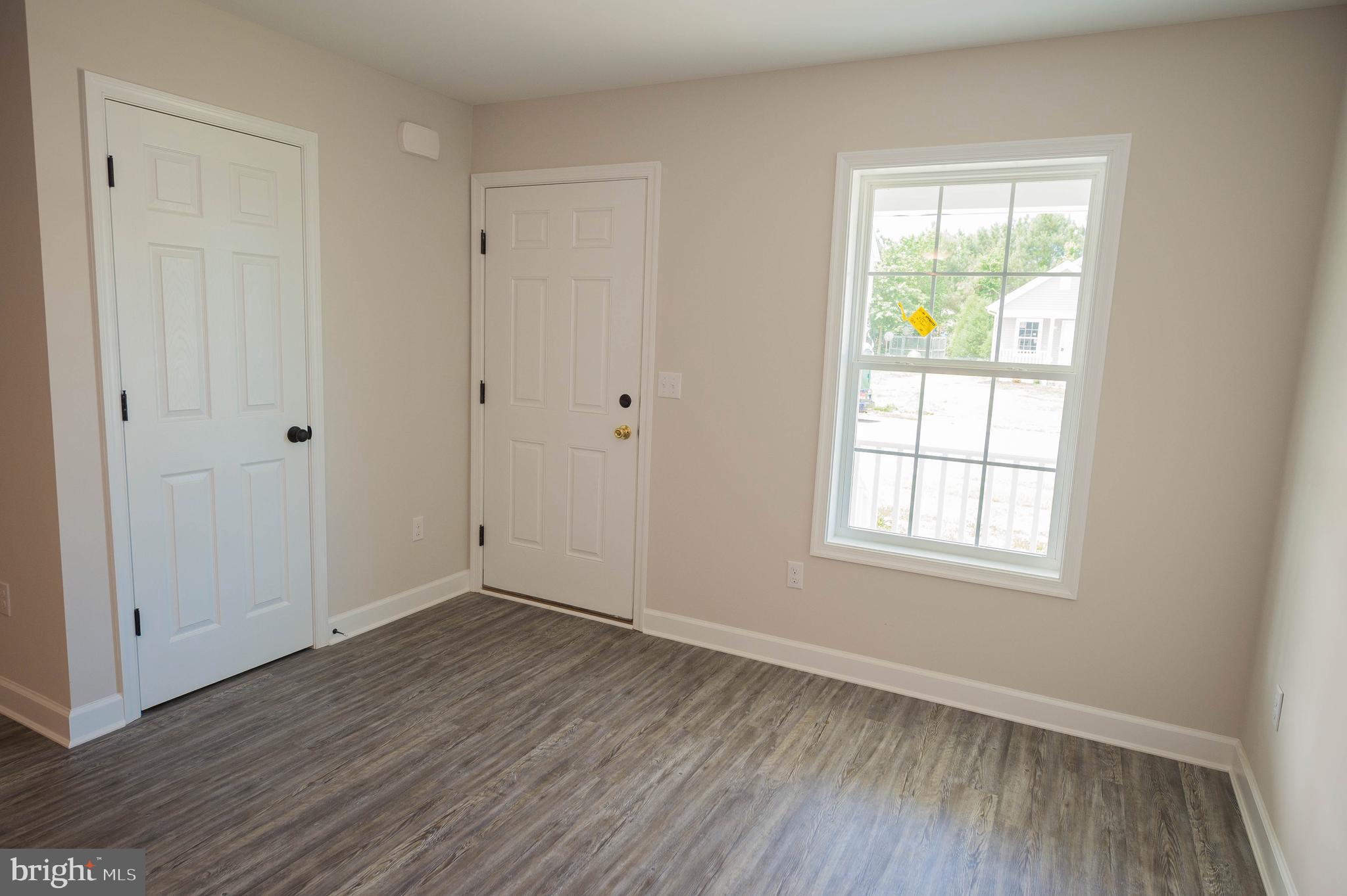 113 Morgan Run Snow Hill, MD 21863 - Photo 5 of 35 an empty room with wooden floor and windows
