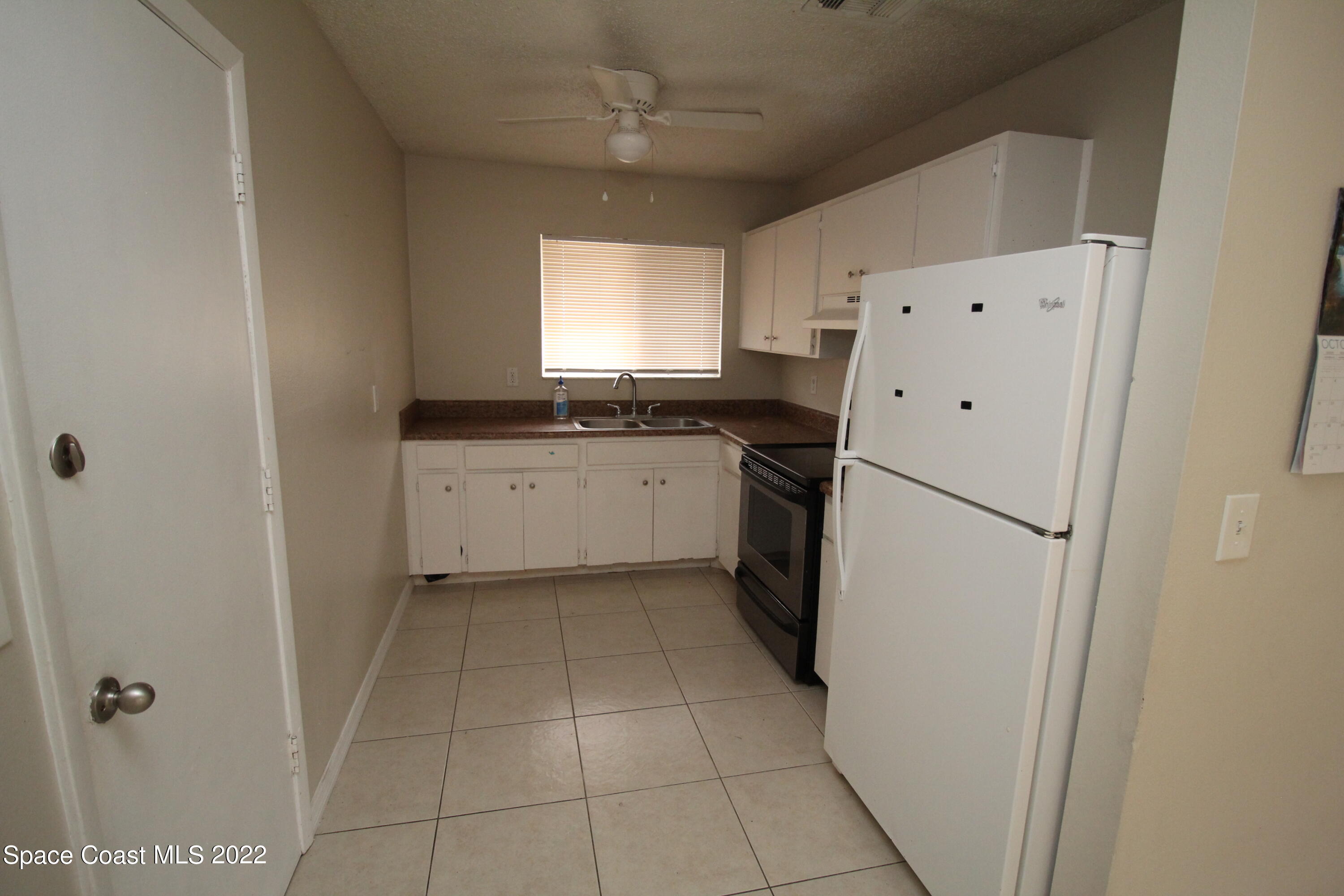 992 Sable Circle Southeast Palm Bay, FL 32909 - Photo 4 of 8 a kitchen with a refrigerator a sink and dishwasher