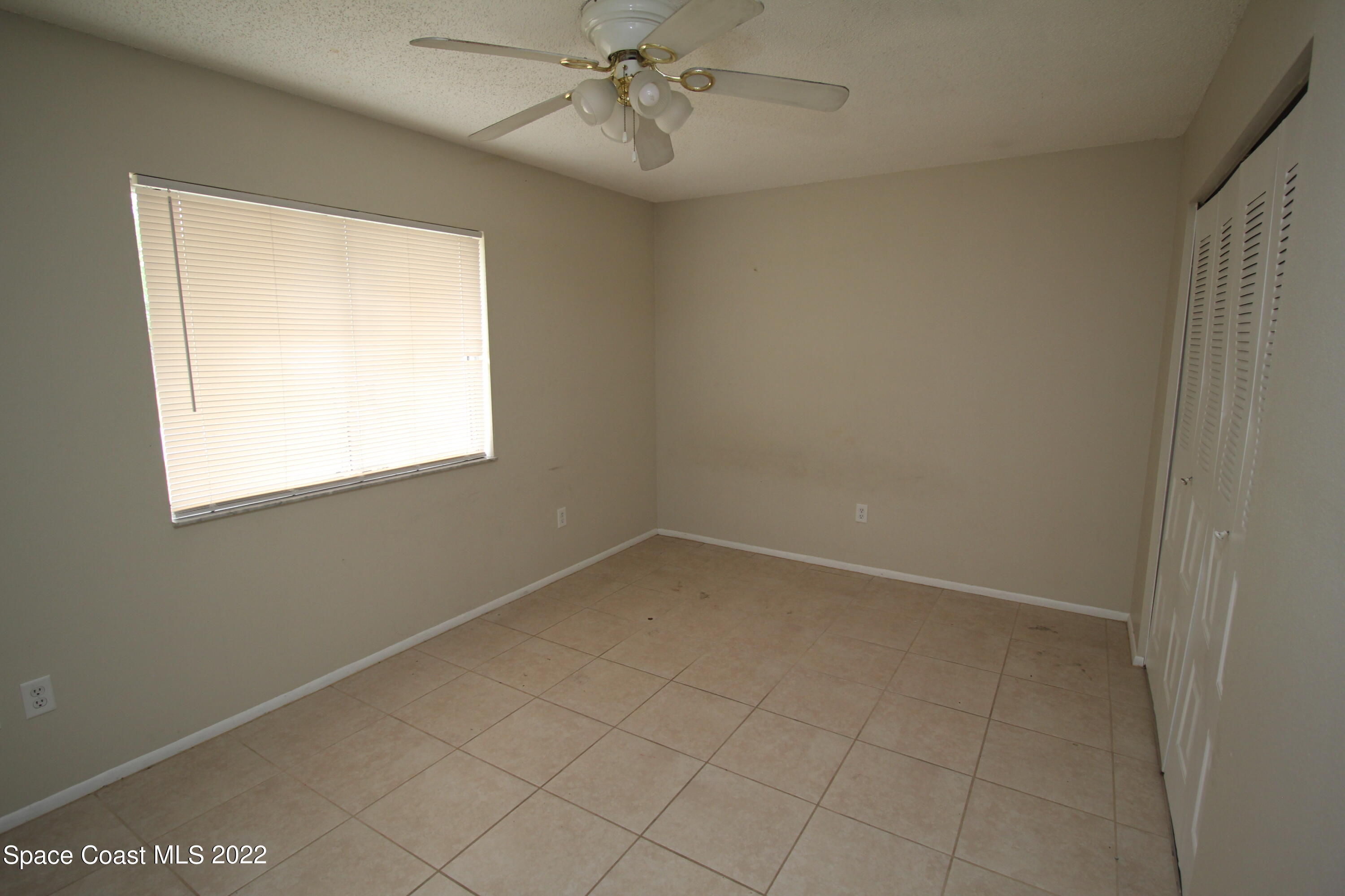 992 Sable Circle Southeast Palm Bay, FL 32909 - Photo 7 of 8 an empty room with a window