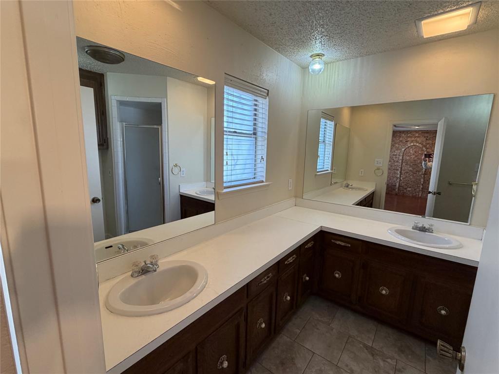 821 East Highway 199 Springtown, TX 76082 - Photo 12 of 26 a bathroom with a sink and a mirror