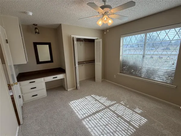 a view of workspace with window and ceiling fan