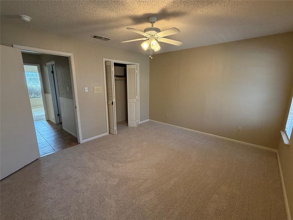821 East Highway 199 Springtown, TX 76082 - Photo 22 of 26 a view of an empty room with a chandelier fan