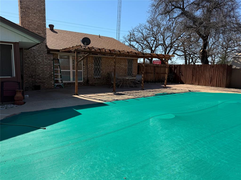 821 East Highway 199 Springtown, TX 76082 - Photo 23 of 26 a front view of a house with a garden and trees