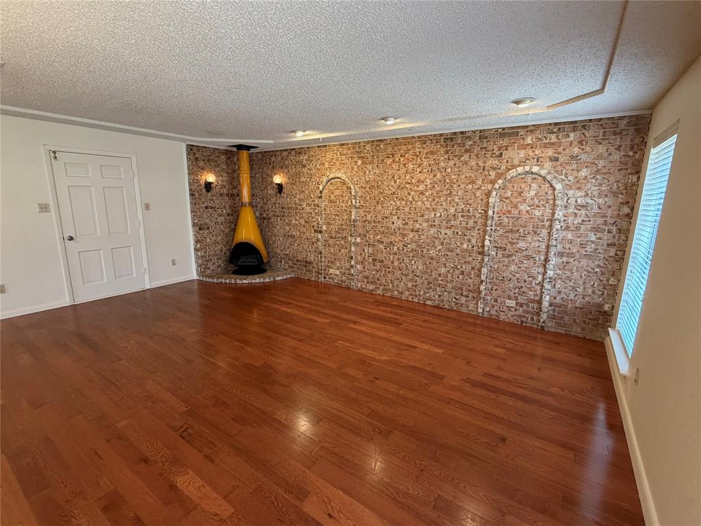821 East Highway 199 Springtown, TX 76082 - Photo 9 of 26 a view of empty room with wooden floor and fan
