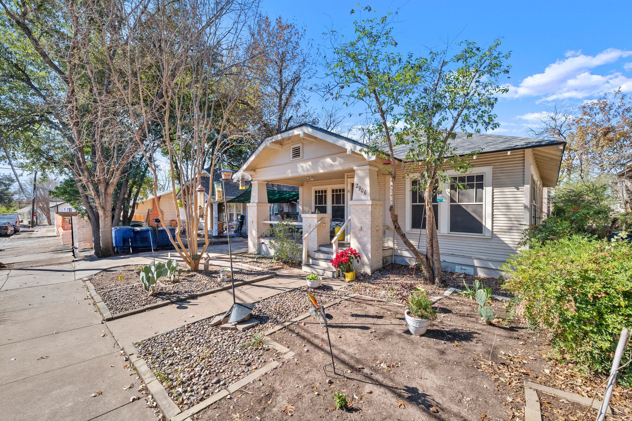 a front view of a house with a tree