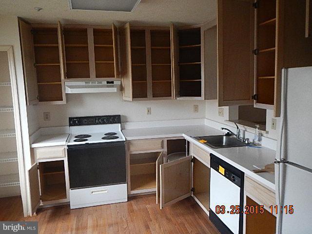 9324 Daly Court Laurel, MD 20723 - Photo 6 of 9 a kitchen with stainless steel appliances granite countertop a stove and a sink