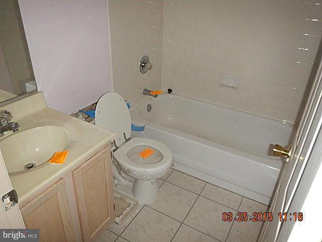 9324 Daly Court Laurel, MD 20723 - Photo 7 of 9 a bathroom with a sink and a mirror