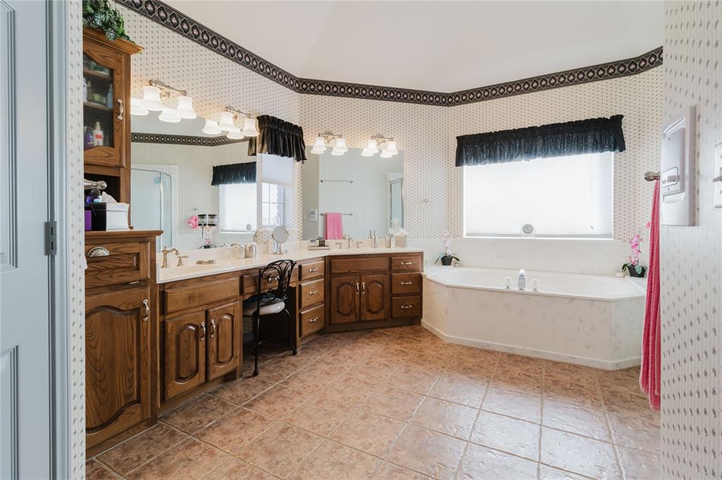 130 Blazek Road Alma, TX 75119 - Photo 23 of 30 Bathroom with tile patterned floors, a tub, and vanity
