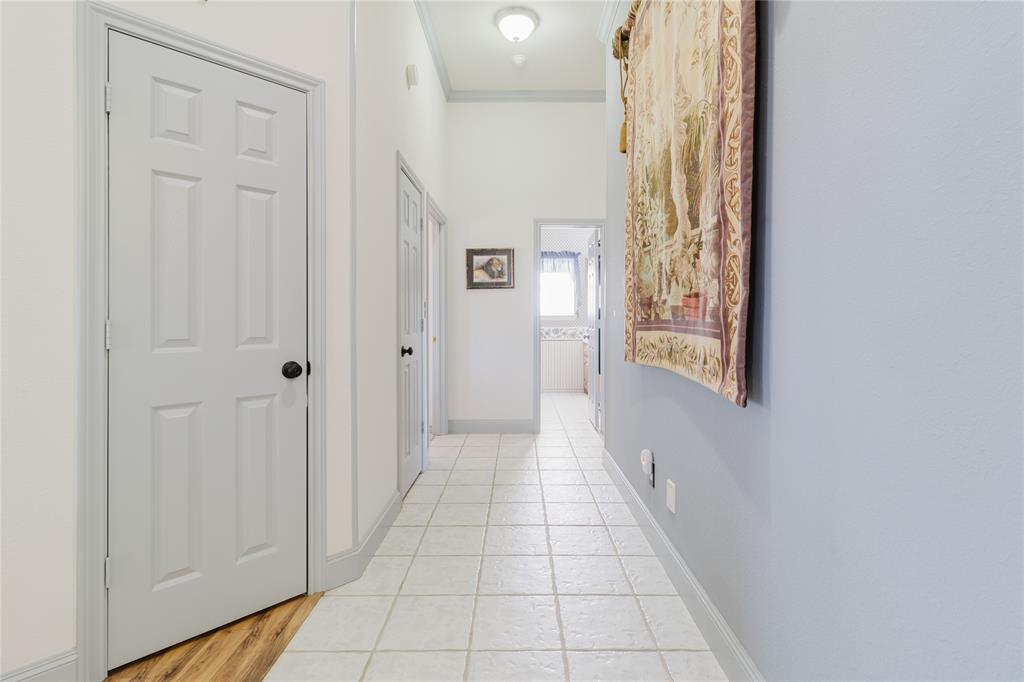 130 Blazek Road Alma, TX 75119 - Photo 26 of 30 Hallway featuring ornamental molding and light tile patterned floors