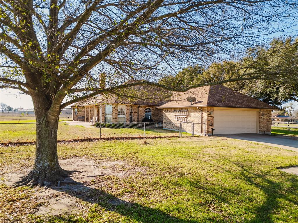 130 Blazek Road Alma, TX 75119 - Photo 5 of 30 View of front of home featuring a garage and a front yard