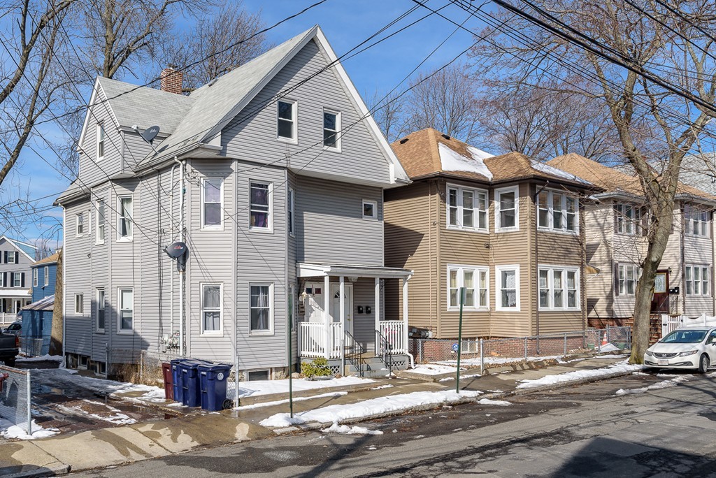 14 Chatham Road Everett, MA 02149 - Photo 2 of 10 a view of a white house with large windows next to a road