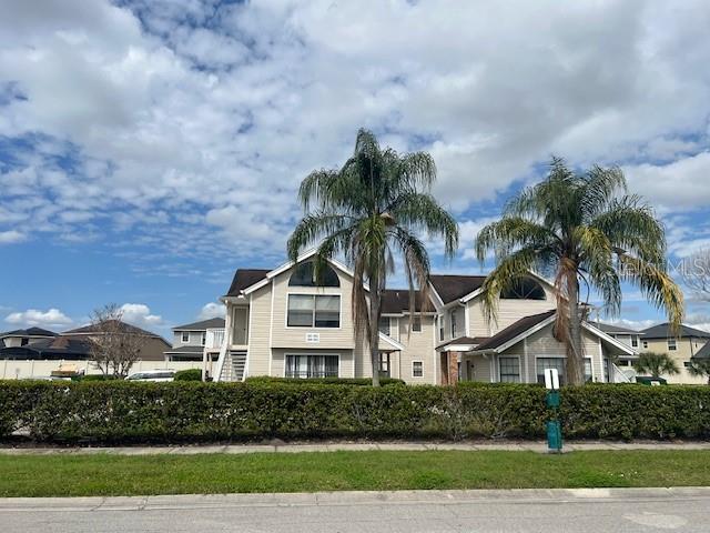 2927 Rio Grande Trail, Unit 2927 Kissimmee, FL 34741 - Photo 10 of 11 a front view of a house with a yard