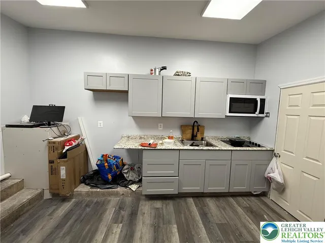 a kitchen with sink cabinets and stainless steel appliances
