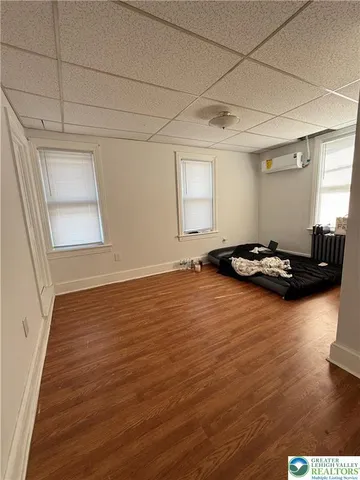 a view of a room with wooden floor