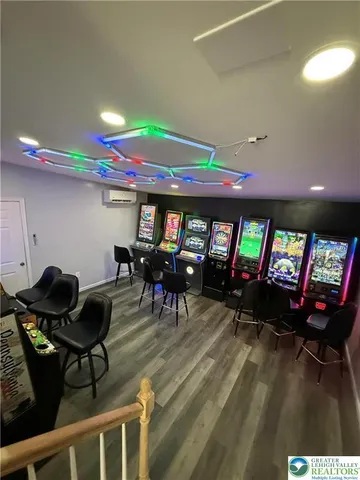 a living room with furniture a piano and a flat screen tv