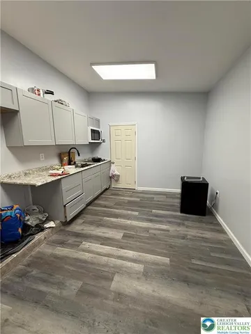 a room with a bed and a television