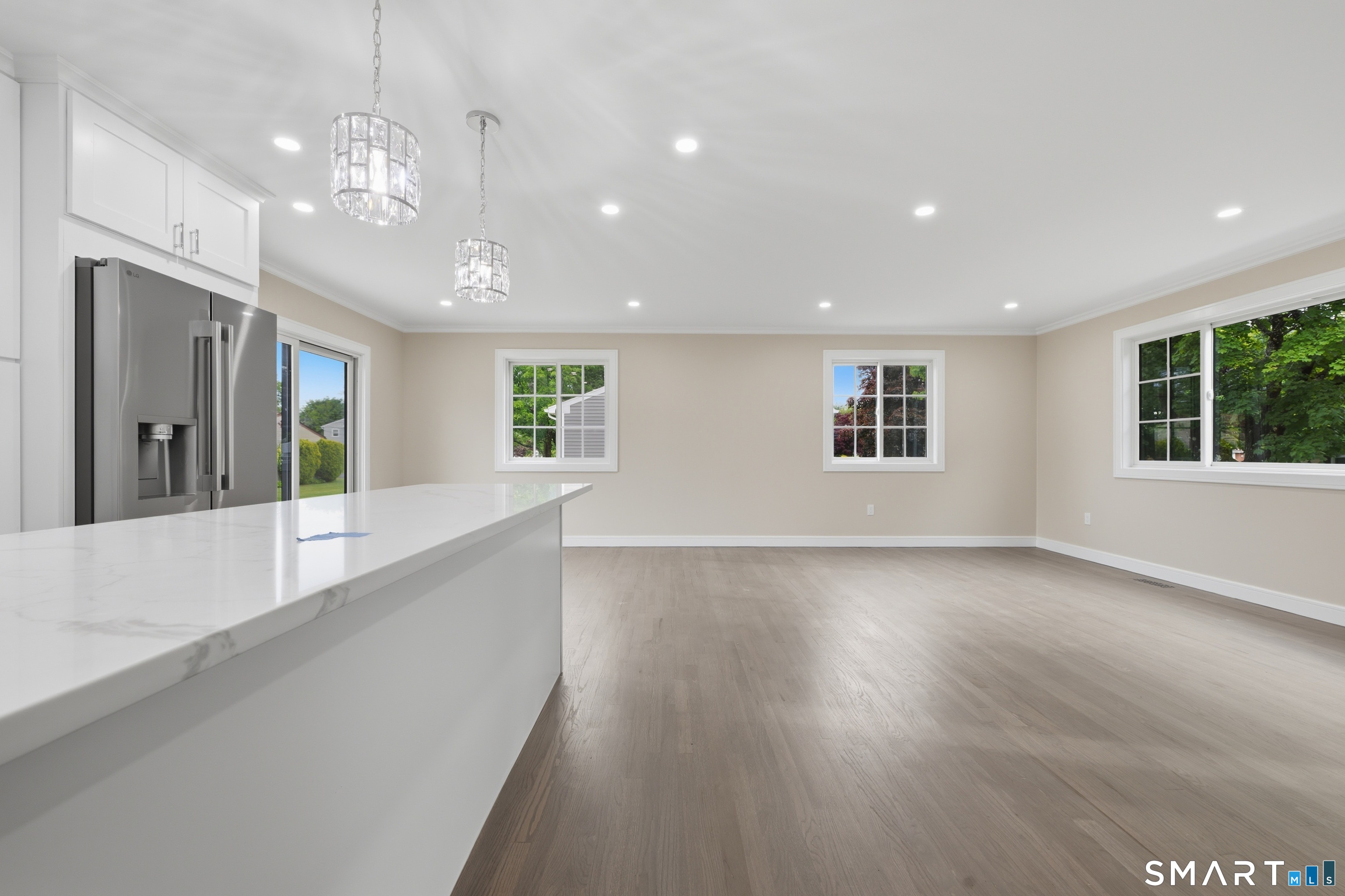 110 Russell Road Stratford, CT 06614 - Photo 7 of 31 an empty room with wooden floor and windows