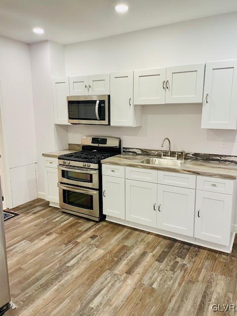281 5th Street Whitehall, PA 18052 - Photo 13 of 36 a kitchen with stainless steel appliances a white stove top oven and cabinets