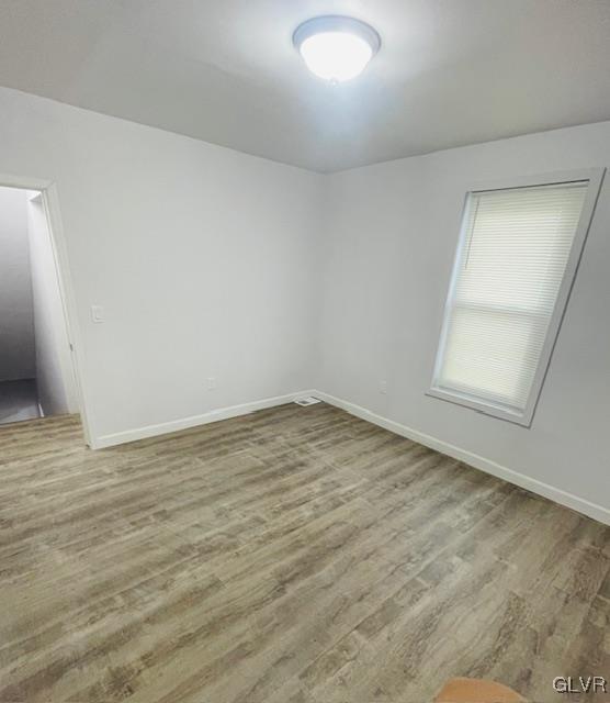 281 5th Street Whitehall, PA 18052 - Photo 25 of 36 an empty room with wooden floor and windows