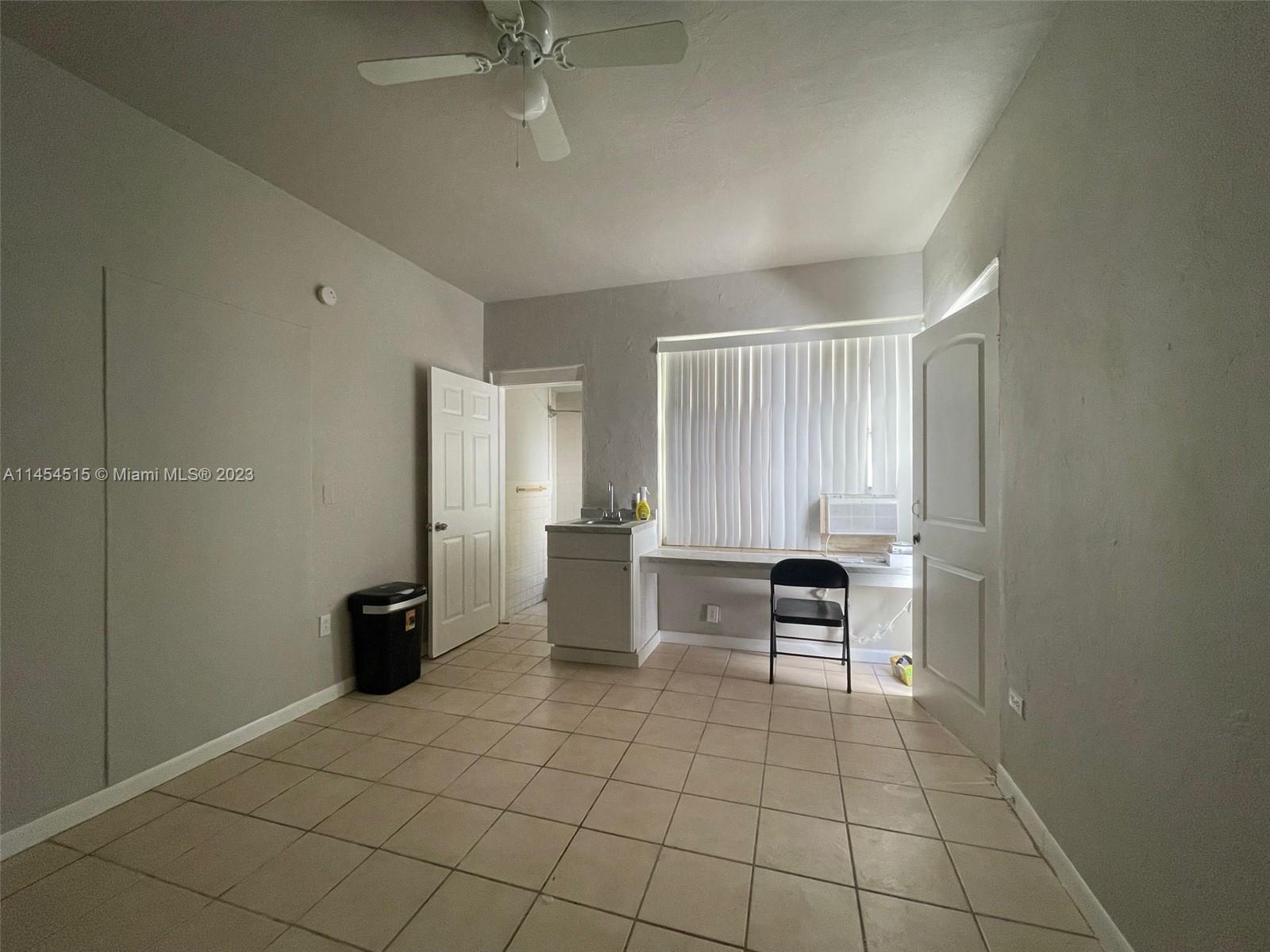 6830 Harding Avenue, Unit 11 Miami Beach, FL 33141 - Photo 2 of 5 a view of an empty room with a window