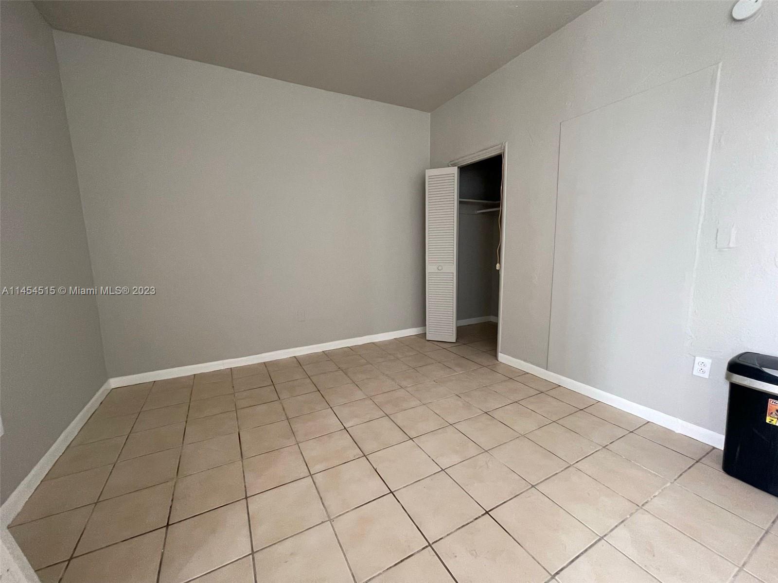 6830 Harding Avenue, Unit 11 Miami Beach, FL 33141 - Photo 3 of 5 a view of an empty room and window