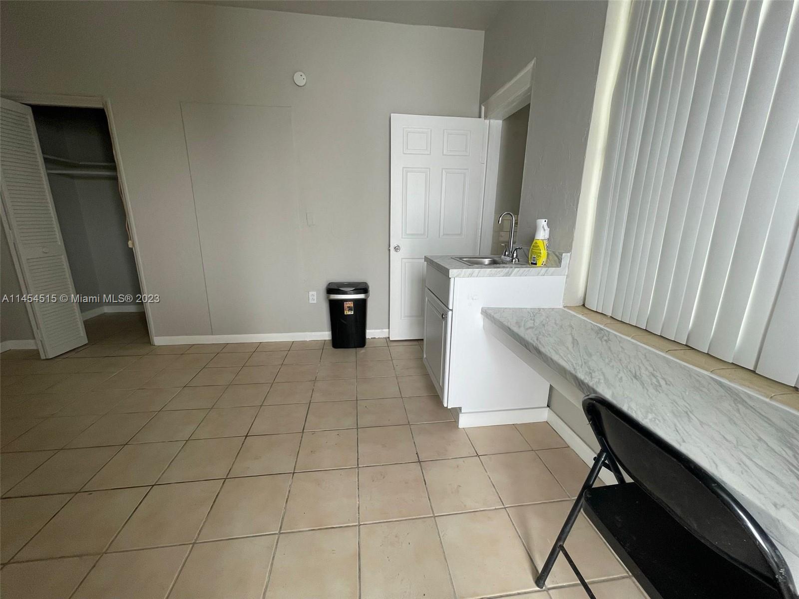 6830 Harding Avenue, Unit 11 Miami Beach, FL 33141 - Photo 4 of 5 a view of an empty room with a window