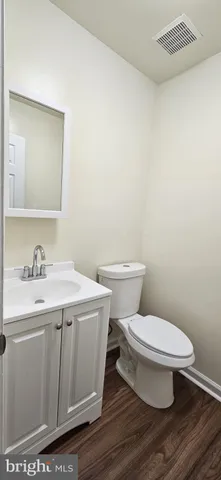 a bathroom with a toilet a sink and mirror