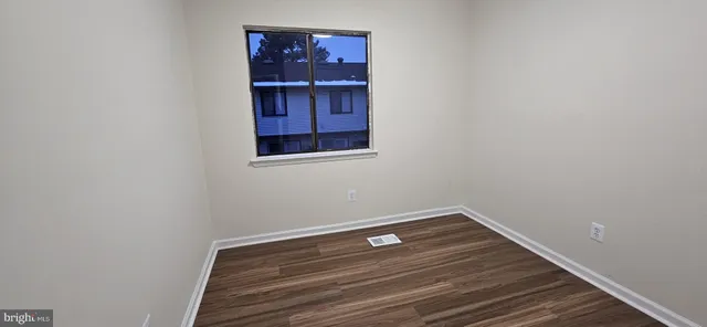 a room with rack on the wall and a window