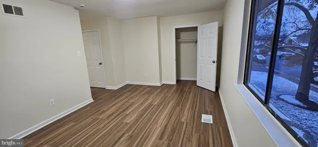 a view of a room with wooden floor and a rug
