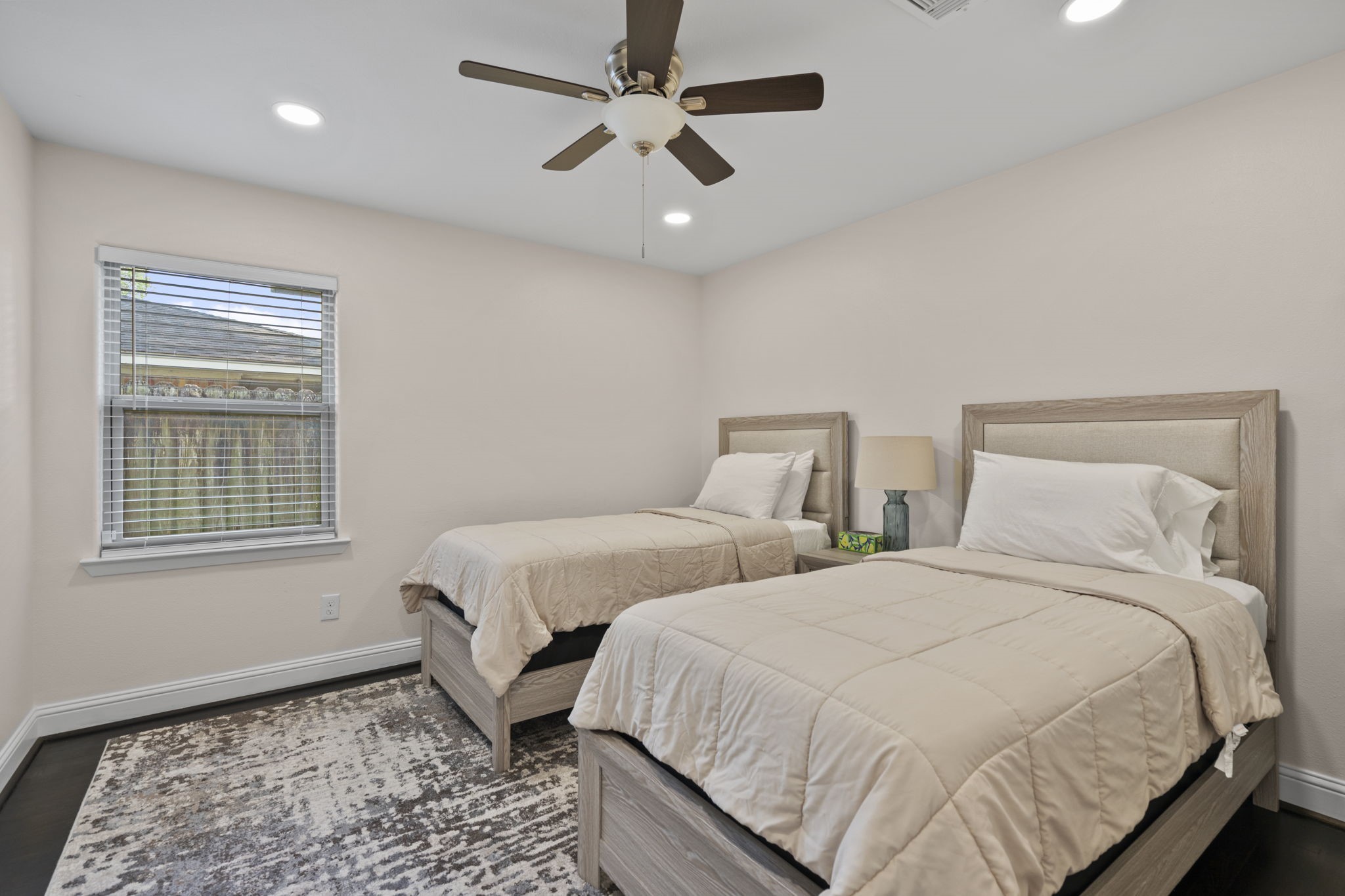2402 Chimney Rock Road Houston, TX 77057 - Photo 28 of 36 Bright secondary bedroom with a large window for natural light, recessed lighting, and a ceiling fan. Versatile layout with clean finishes, ideal for guests or additional living space.