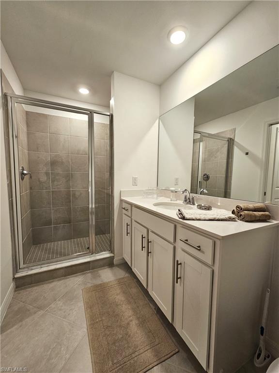 5749 Double Eagle Circle, Unit 4523 Immokalee, FL 34142 - Photo 11 of 47 a bathroom with a shower sink and mirror