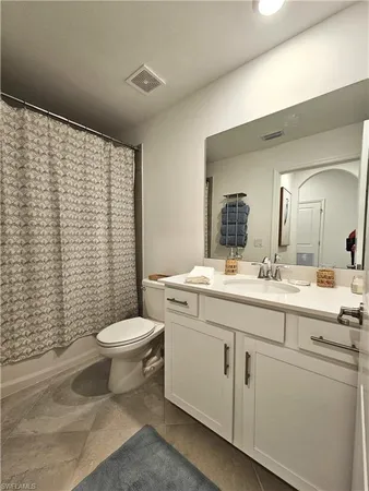 a bathroom with a toilet a sink and a mirror