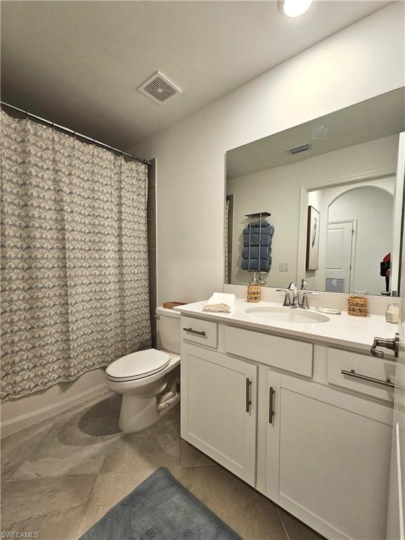 5749 Double Eagle Circle, Unit 4523 Immokalee, FL 34142 - Photo 13 of 47 a bathroom with a toilet a sink and a mirror