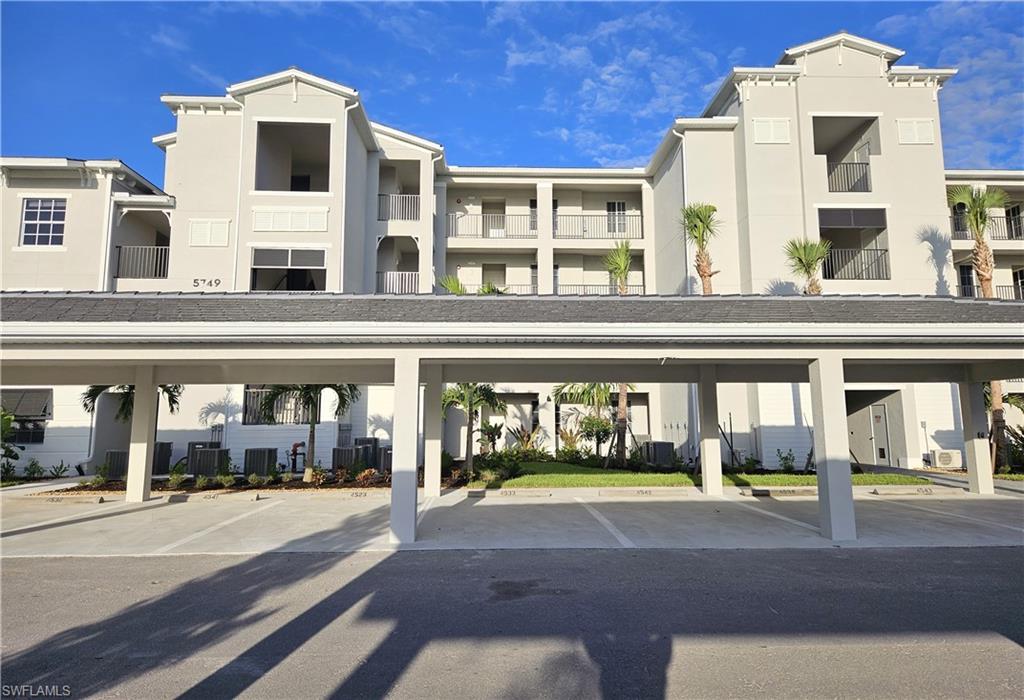 5749 Double Eagle Circle, Unit 4523 Immokalee, FL 34142 - Photo 17 of 47 a front view of building with street