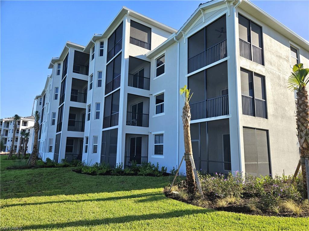 5749 Double Eagle Circle, Unit 4523 Immokalee, FL 34142 - Photo 19 of 47 a view of a building next to a yard