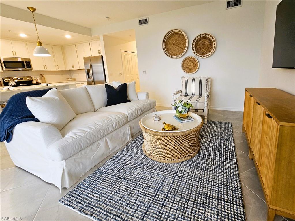 5749 Double Eagle Circle, Unit 4523 Immokalee, FL 34142 - Photo 4 of 47 a living room with a couch and a table