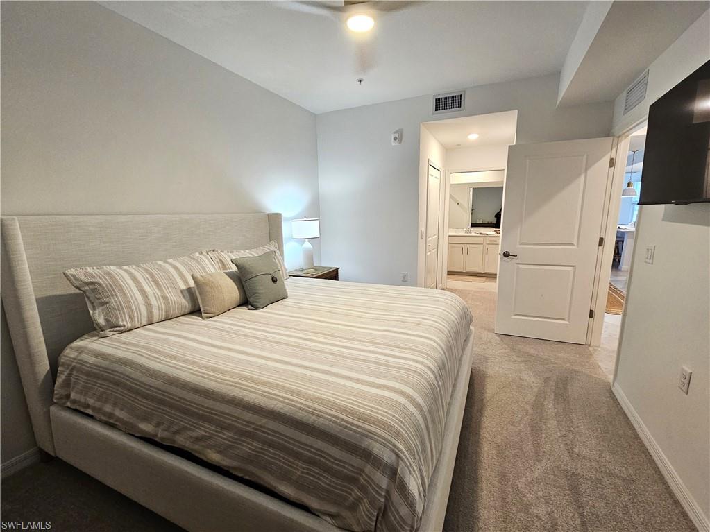 5749 Double Eagle Circle, Unit 4523 Immokalee, FL 34142 - Photo 5 of 47 a large white bed in a white room