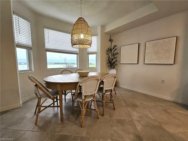 a view of a dining room and livingroom with furniture window and wooden floor