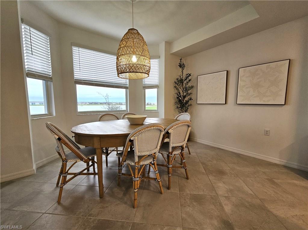 5749 Double Eagle Circle, Unit 4523 Immokalee, FL 34142 - Photo 7 of 47 a view of a dining room and livingroom with furniture window and wooden floor