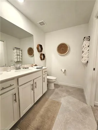a spacious bathroom with a double vanity sink mirror and toilet