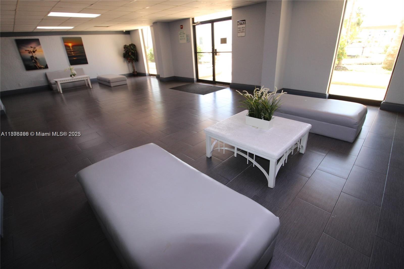 13499 Biscayne Boulevard, Unit 404 North Miami, FL 33181 - Photo 3 of 7 a living room with furniture and a table