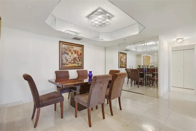 a view of a dining room with furniture and a chandelier