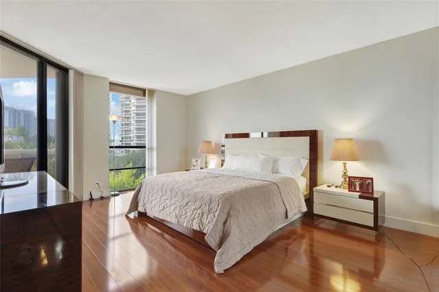 a bedroom with a bed and large window